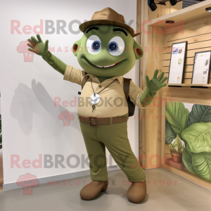 Olive Trapeze Artist mascot costume character dressed with a Chinos and Smartwatches