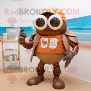 Brown Hermit Crab mascot costume character dressed with a Graphic Tee and Reading glasses