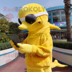 Yellow Dolphin mascot costume character dressed with a Sweater and Reading glasses