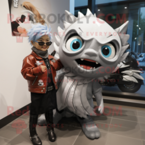 Silver Tuna mascot costume character dressed with a Moto Jacket and Hair clips