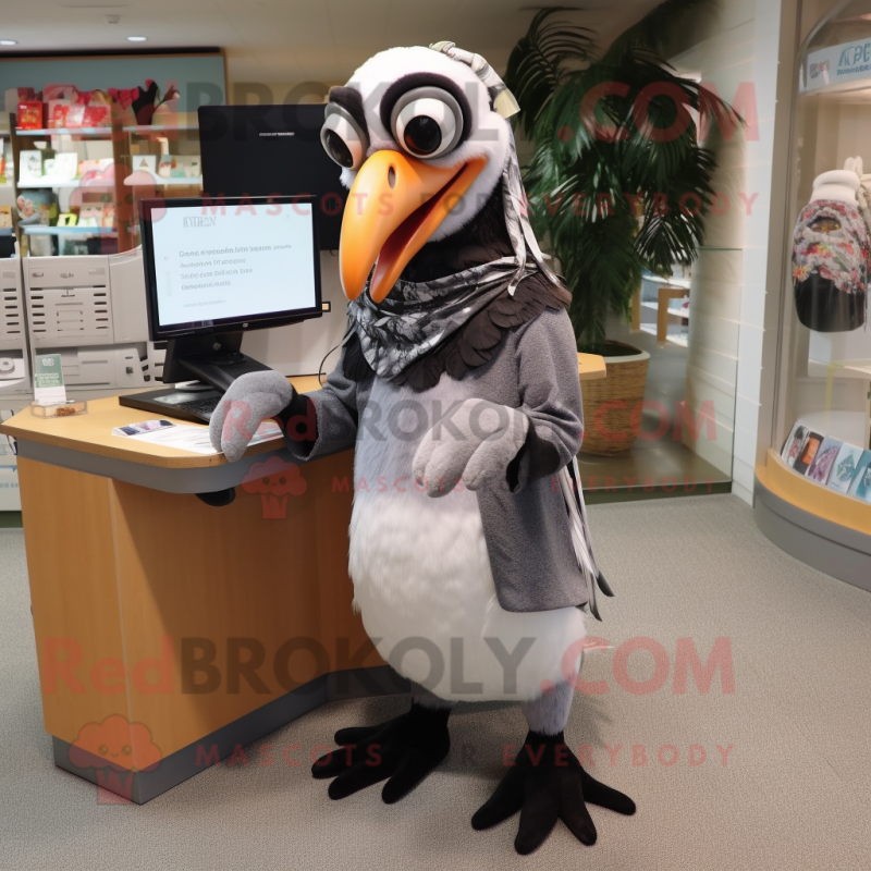 Silver Toucan mascot costume character dressed with a Wrap Dress and Reading glasses