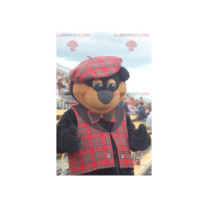 Mascote urso preto e marrom em traje escocês - Redbrokoly.com