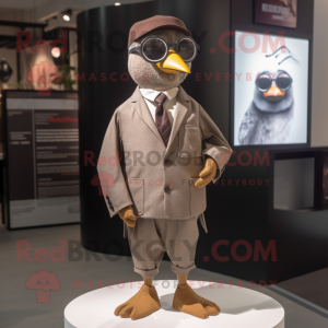 Brown Dove mascot costume character dressed with a Suit Jacket and Headbands