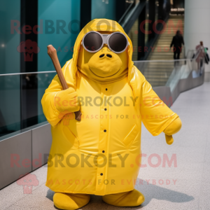 Yellow Walrus mascot costume character dressed with a Raincoat and Sunglasses