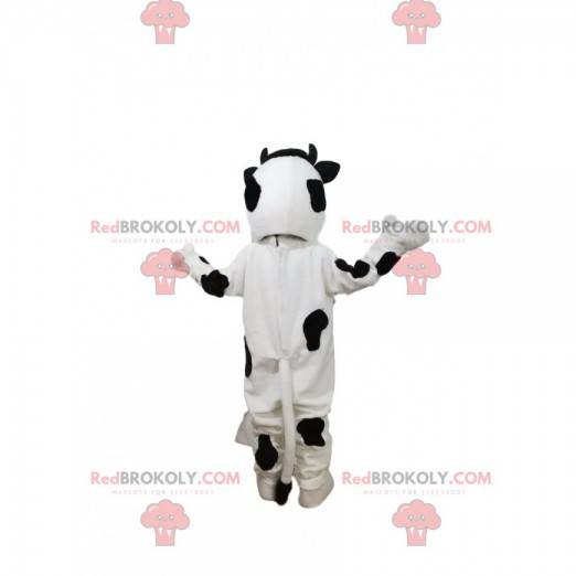 Mascote vaca preto e branco com um grande sorriso -