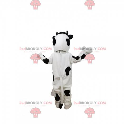 Mascotte della mucca in bianco e nero con un grande sorriso -