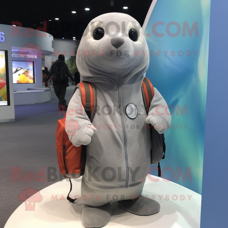 Gray Seal mascot costume character dressed with a Hoodie and Messenger bags Gray Seal mascot costume character dressed with a Hoodie and Messenger bags