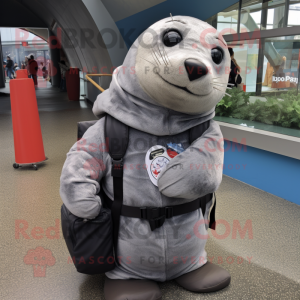 Gray Seal mascot costume character dressed with a Hoodie and Messenger bags