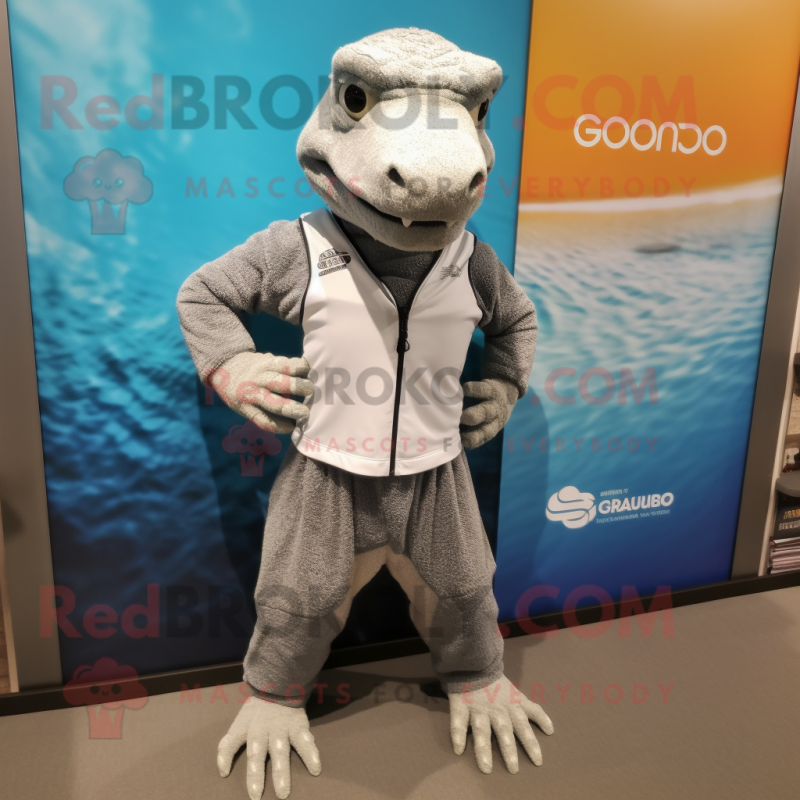 Silver Komodo Dragon mascot costume character dressed with a Board Shorts and Bracelet watches Silver Komodo Dragon mascot costume character dressed with a Board Shorts and Bracelet watches