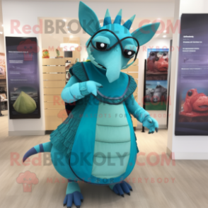 Turquoise Armadillo mascot costume character dressed with a Empire Waist Dress and Eyeglasses