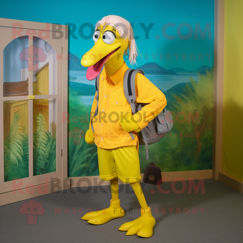 Yellow Flamingo mascot costume character dressed with a Capri Pants and Backpacks Yellow Flamingo mascot costume character dressed with a Capri Pants and Backpacks