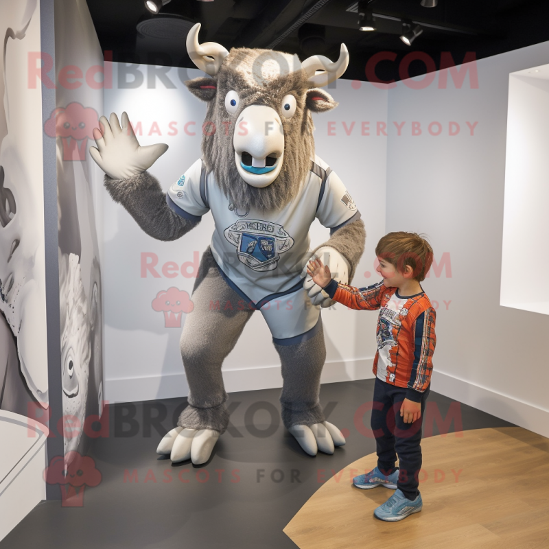 Silver Minotaur mascot costume character dressed with a Rugby Shirt and Wraps