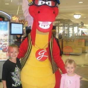 Mascotte de dinosaure rouge et jaune avec des lunettes