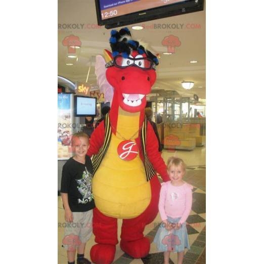 Rotes und gelbes Dinosauriermaskottchen mit Brille -
