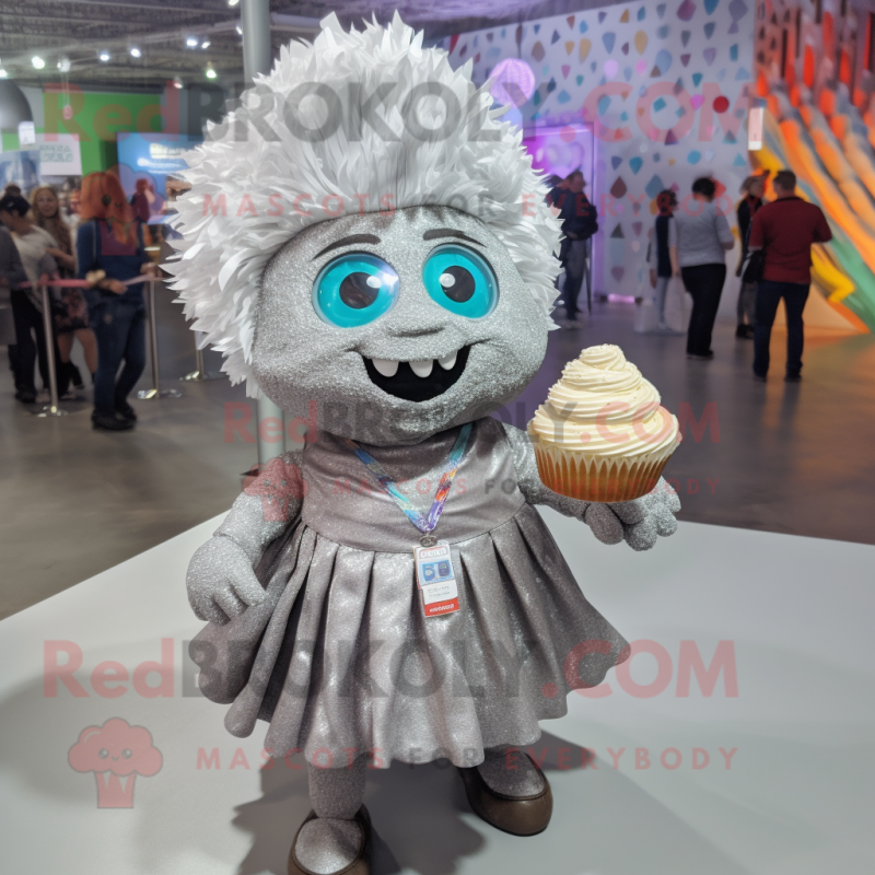 Silver Cupcake mascot costume character dressed with a Button-Up Shirt and Shawl pins