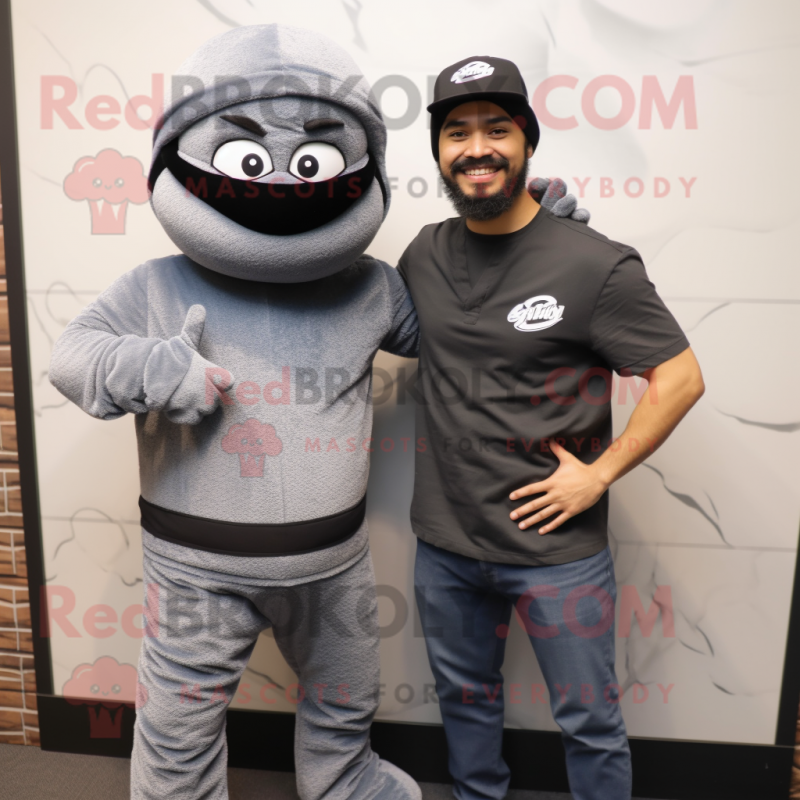 Gray Ninja mascot costume character dressed with a Henley Tee and Berets Gray Ninja mascot costume character dressed with a Henley Tee and Berets