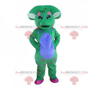 Mascote de dinossauro azul e verde pastel com um puff -