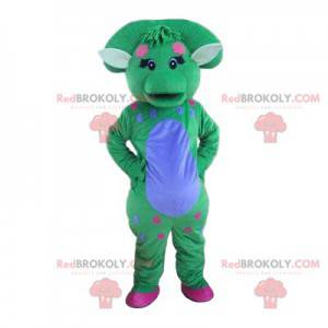 Mascote de dinossauro azul e verde pastel com um puff -