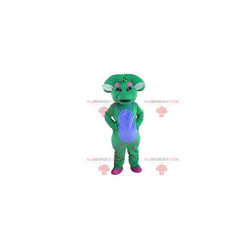 Mascote de dinossauro azul e verde pastel com um puff -