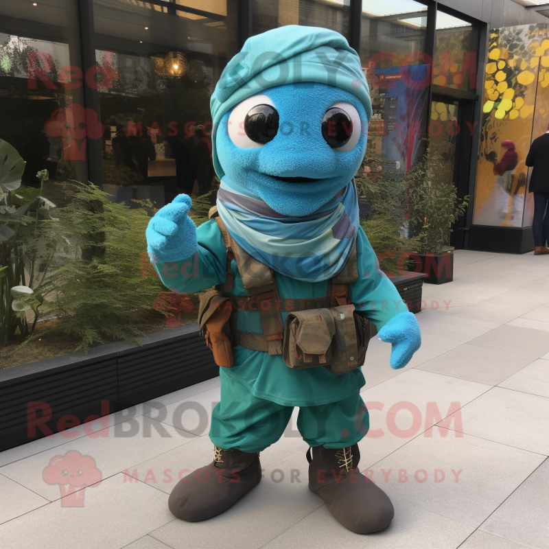 Turquoise Commando mascot costume character dressed with a Trousers and Scarves