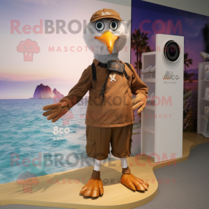 Brown Gull mascot costume character dressed with a Board Shorts and Smartwatches