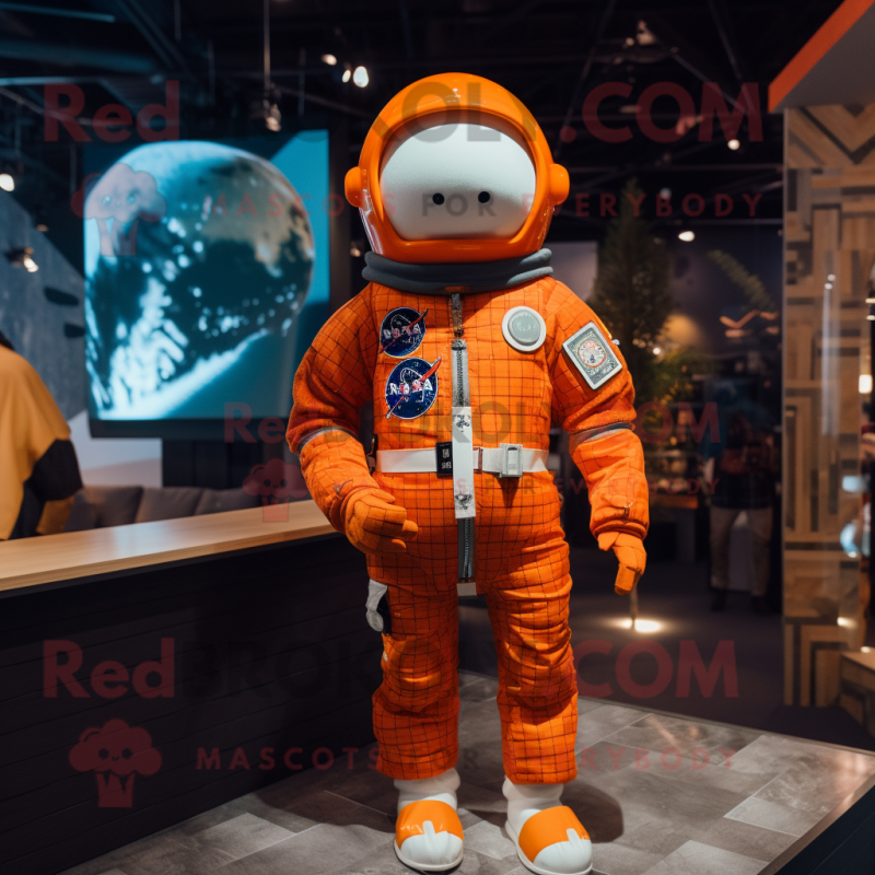 Orange Astronaut mascot costume character dressed with a Flannel Shirt and Berets Orange Astronaut mascot costume character dressed with a Flannel Shirt and Berets