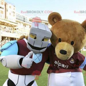 2 mascotas, un oso pardo y un robot blanco, azul y morado -