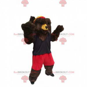 Brun björnmaskot med röda shorts och en marin baddräkt -