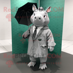 Gray Rhinoceros mascot costume character dressed with a Raincoat and Briefcases