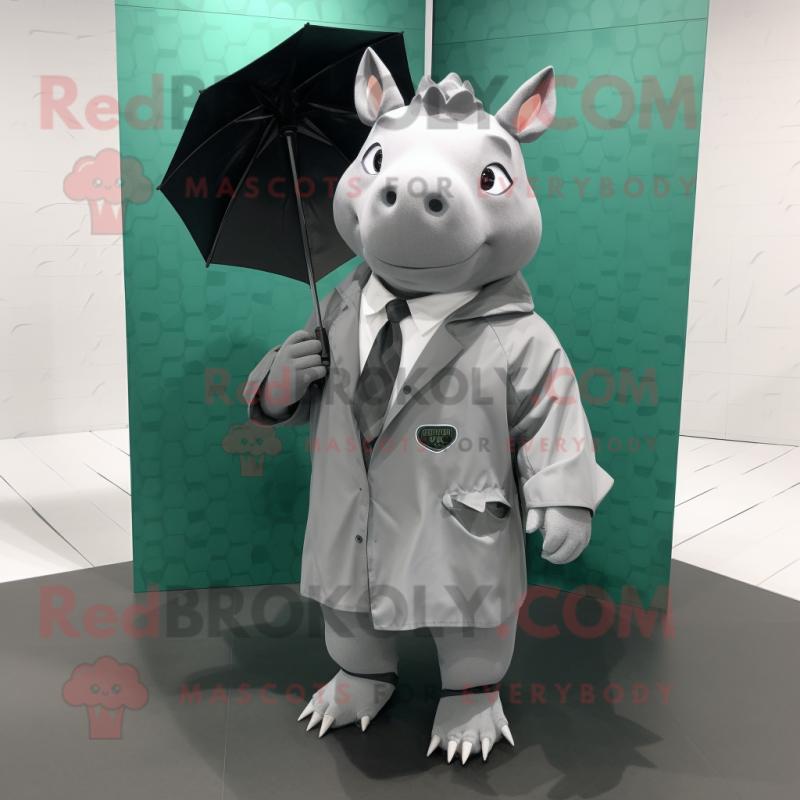 Gray Rhinoceros mascot costume character dressed with a Raincoat and Briefcases Gray Rhinoceros mascot costume character dressed with a Raincoat and Briefcases
