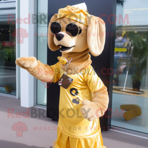 Gold Dog mascot costume character dressed with a Maxi Dress and Eyeglasses
