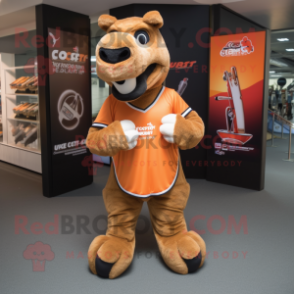 Rust Camel mascot costume character dressed with a Rugby Shirt and Clutch bags