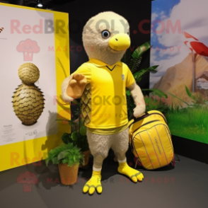 Lemon Yellow Pangolin mascot costume character dressed with a Board Shorts and Tote bags