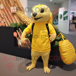 Lemon Yellow Pangolin mascot costume character dressed with a Board Shorts and Tote bags