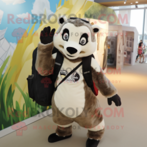 Tan Badger mascot costume character dressed with a Graphic Tee and Messenger bags