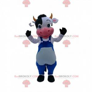 Mascotte della mucca in bianco e nero con tuta blu -
