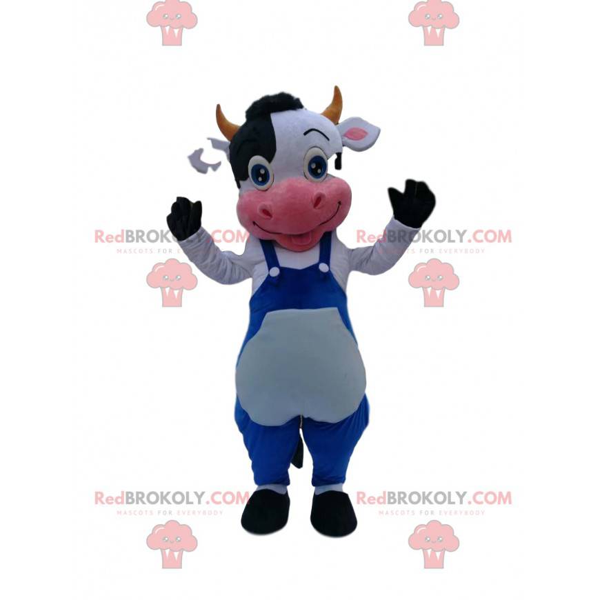 Mascotte de vache noire et blanche avec une salopette bleu -