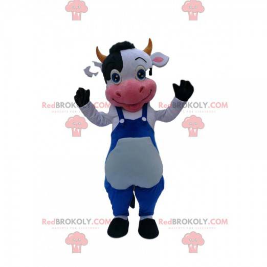 Mascotte de vache noire et blanche avec une salopette bleu -