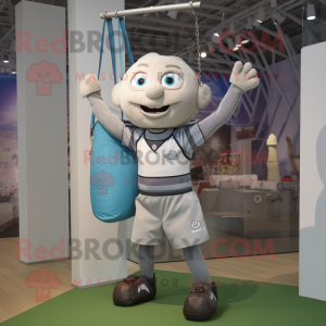 Silver Trapeze Artist mascot costume character dressed with a Rugby Shirt and Tote bags
