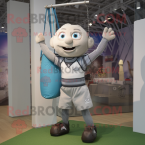 Silver Trapeze Artist mascot costume character dressed with a Rugby Shirt and Tote bags