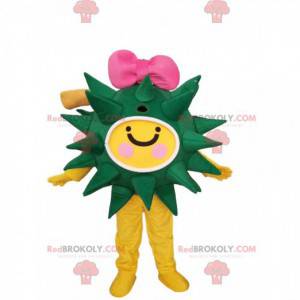 Green and yellow virus mascot with a pink bow tie -