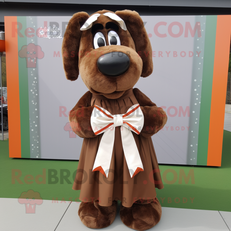 Brown Shepard'S Pie mascot costume character dressed with a Maxi Skirt and Bow ties Brown Shepard'S Pie mascot costume character dressed with a Maxi Skirt and Bow ties