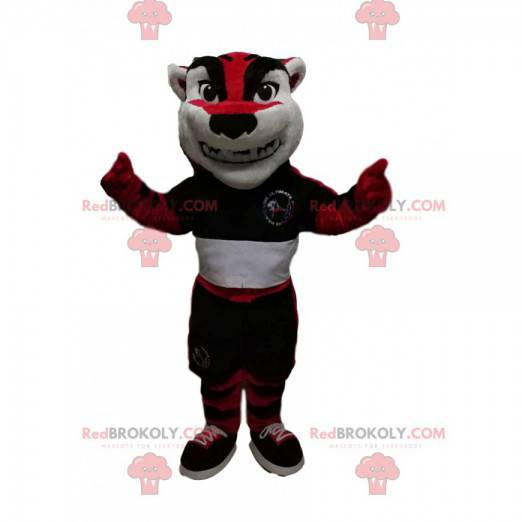 Mascotte de tigre rouge et noir avec une tenue de sport -