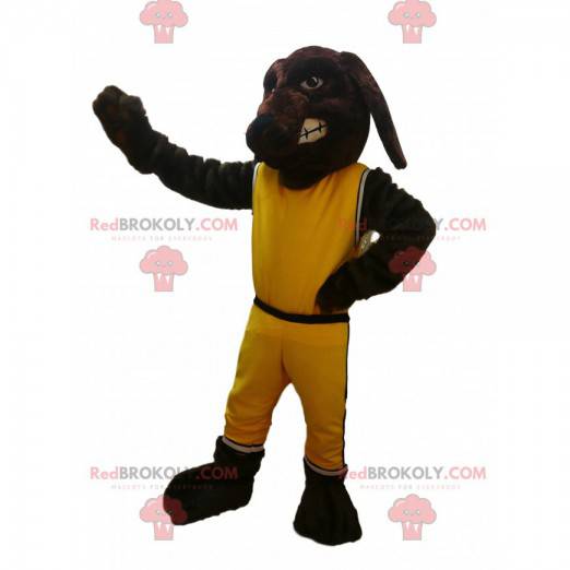 Braunes Hundemaskottchen mit gelber Sportbekleidung -