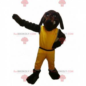 Mascote cachorro marrom com roupa esportiva amarela -