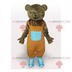 Braunbärenmaskottchen mit orangefarbenem Overall -