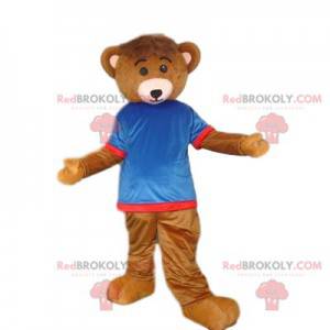 Mascote urso pardo com uma camisa azul e vermelha -