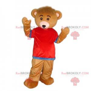 Mascote urso marrom muito fofo com uma camisa vermelha e azul -