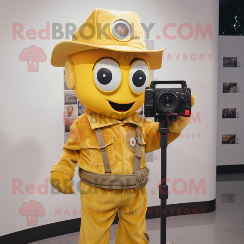 Gold Camera mascot costume character dressed with a Overalls and Hat pins