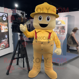 Gold Camera mascot costume character dressed with a Overalls and Hat pins